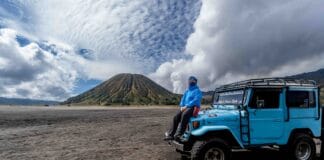 Reliable East Java tour transportation featuring a 4x4 jeep crossing the Bromo sand sea